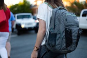 women wearing a grey backpack outside