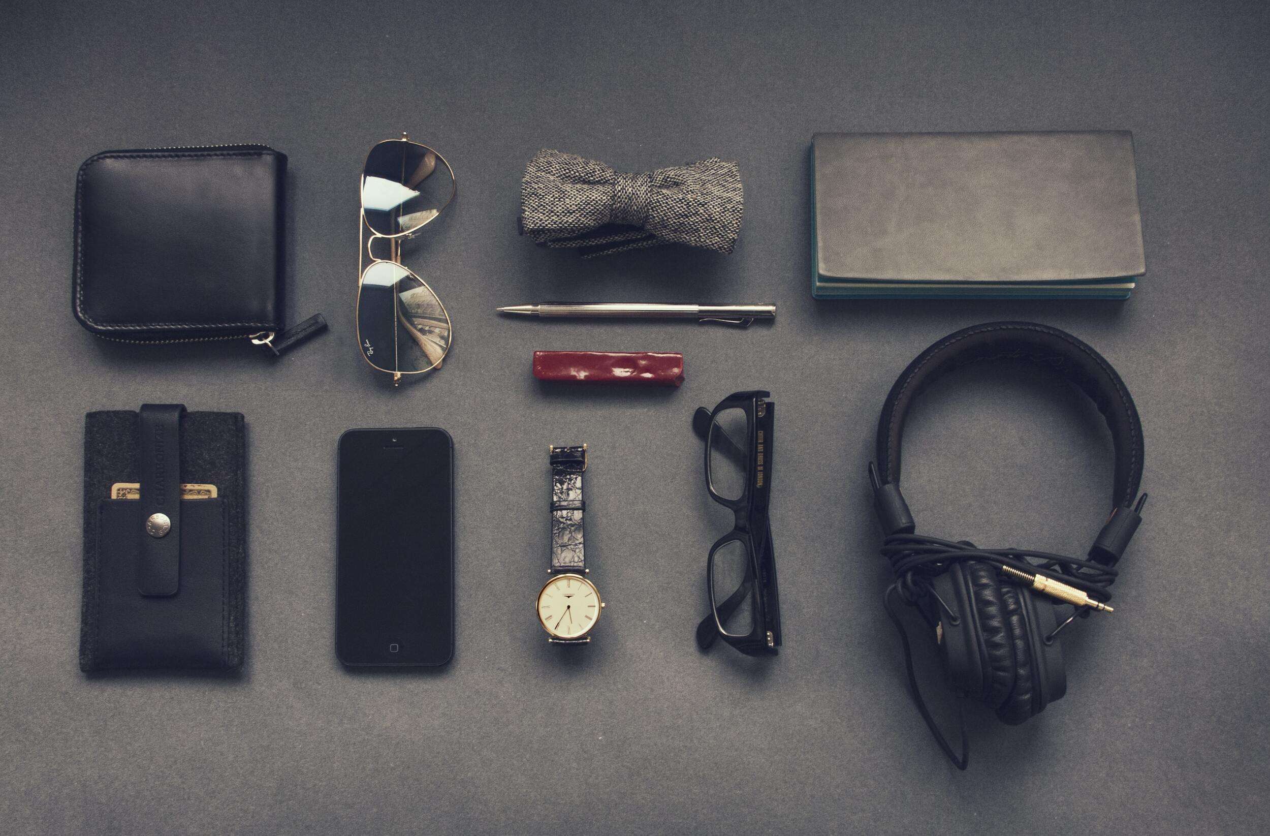 11 items in an edc kit laid out on a grey background