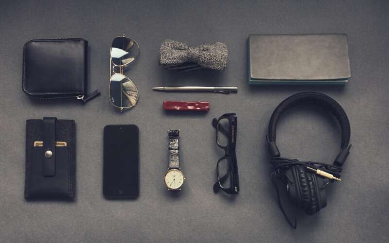 11 items in an edc kit laid out on a grey background
