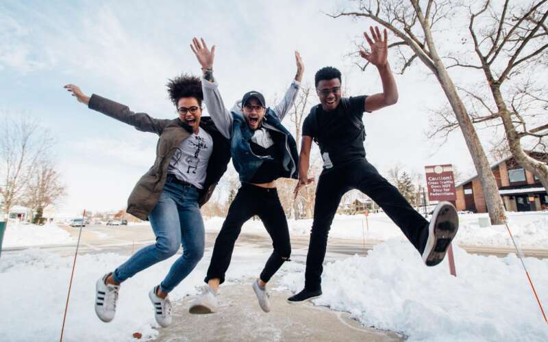 Cole students jumping in the snow during winter break