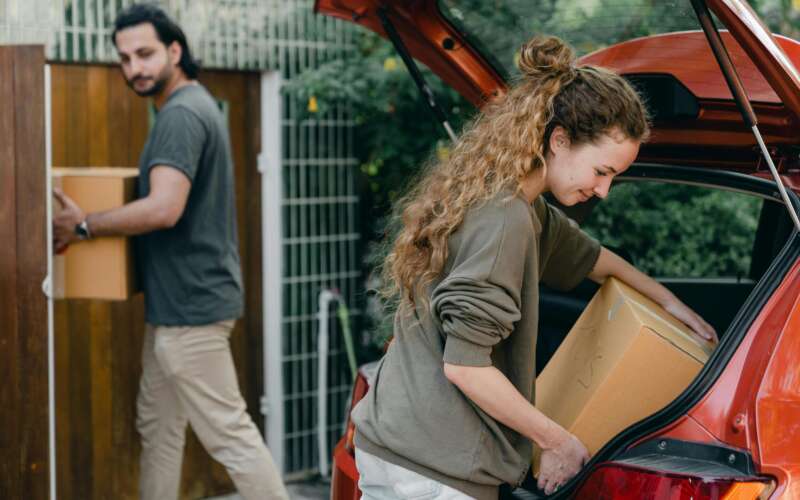 Man and women unpacking the boxes from their car