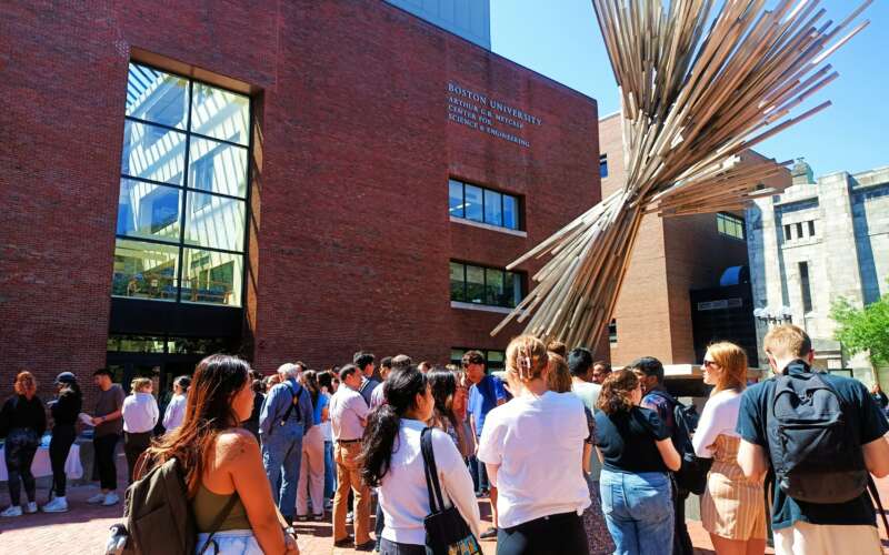 College students standing in front of building on Boston University campus