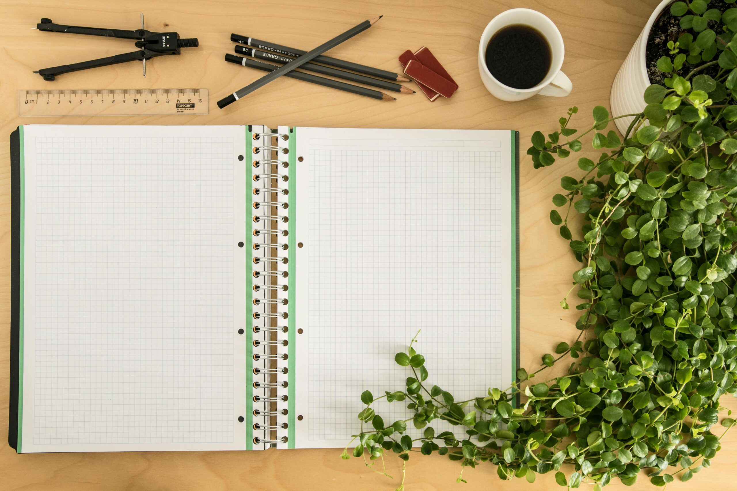 Open notebook with blank pages laying on a table