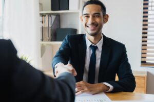 Guy in a suit shaking hands with interviewer