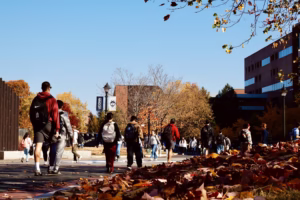 Students on walking UConn campus during a fall day