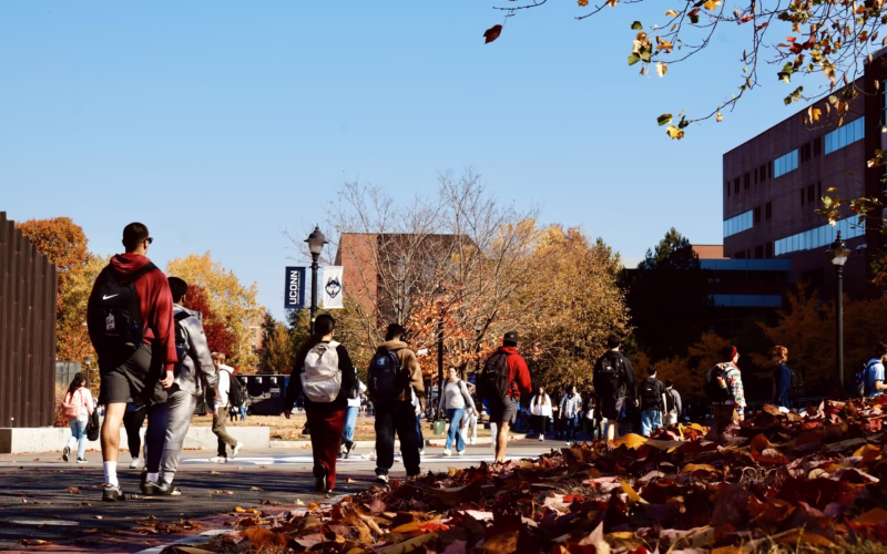 Students on walking UConn campus during a fall day