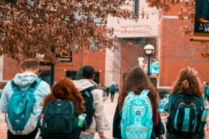 College freshman with backpacks on walking back to their dorms during the day